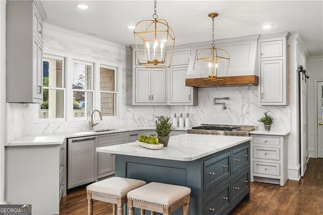 kitchen with a kitchen island, ornamental molding, dark wood-type flooring, pendant lighting, and gray cabinets