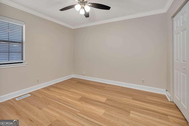 spare room featuring ornamental molding, light wood-type flooring, and ceiling fan