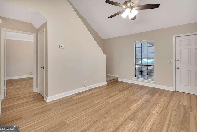 interior space with ceiling fan, lofted ceiling, and light wood-type flooring