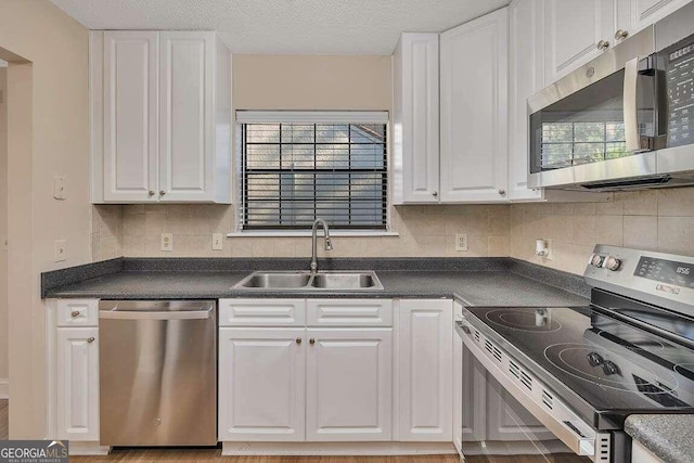 kitchen featuring sink, white cabinetry, and stainless steel appliances