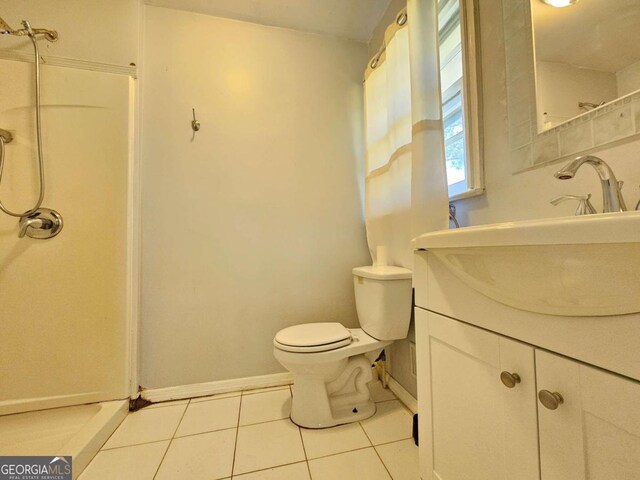 bathroom featuring vanity, a shower, and toilet