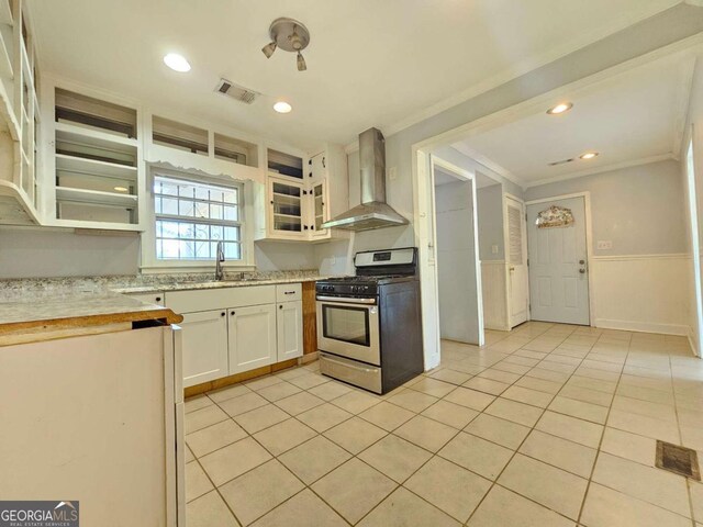 kitchen featuring white cabinetry, gas range, crown molding, wall chimney exhaust hood, and sink