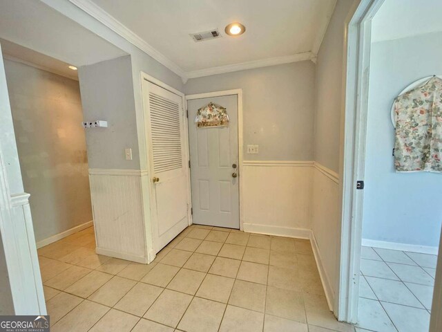 tiled foyer entrance with ornamental molding