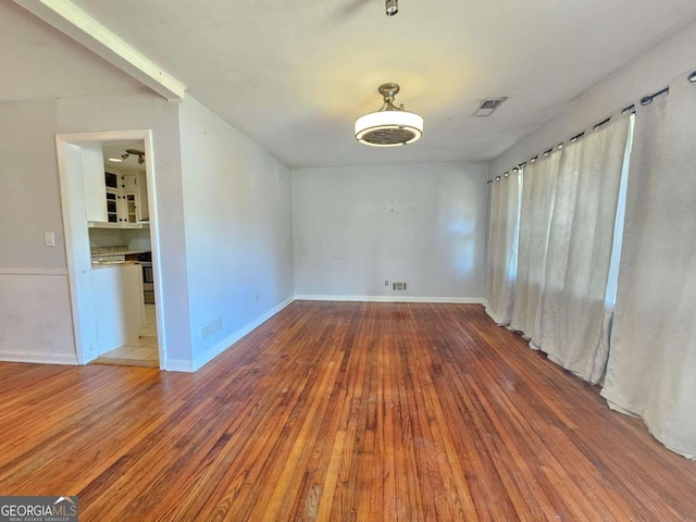 empty room with hardwood / wood-style floors