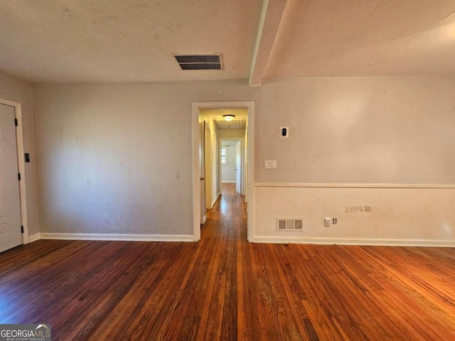 empty room featuring dark wood-type flooring