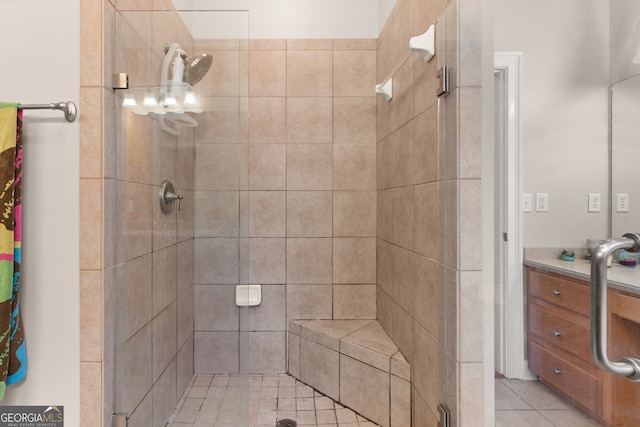 bathroom with vanity, walk in shower, and tile patterned flooring