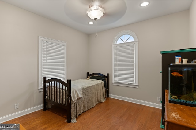 bedroom with ceiling fan and wood-type flooring