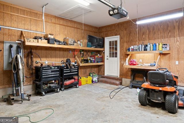 garage featuring a garage door opener and wood walls