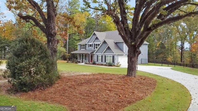 view of front of property with a front yard and a garage