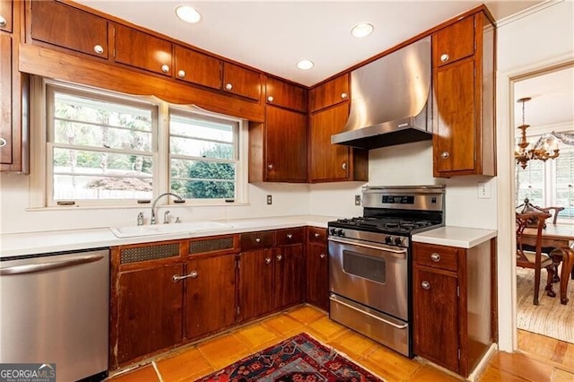 kitchen with a wealth of natural light, sink, exhaust hood, and appliances with stainless steel finishes