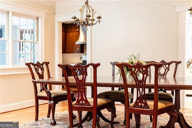 tiled dining room featuring ornamental molding and an inviting chandelier