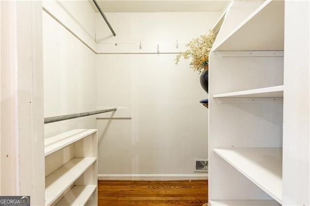 spacious closet featuring hardwood / wood-style floors