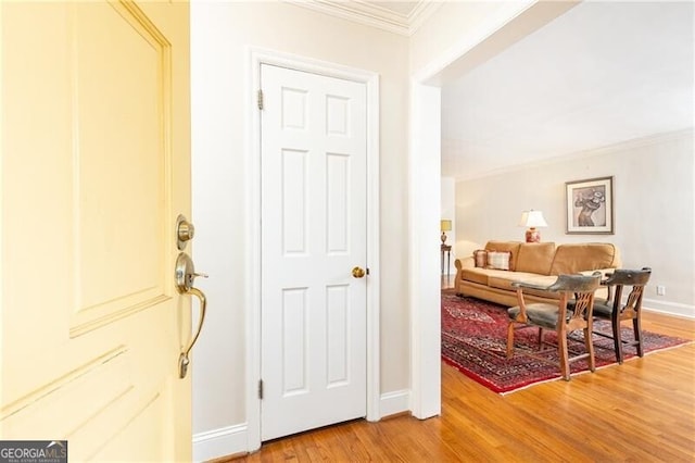 foyer entrance featuring wood-type flooring and ornamental molding