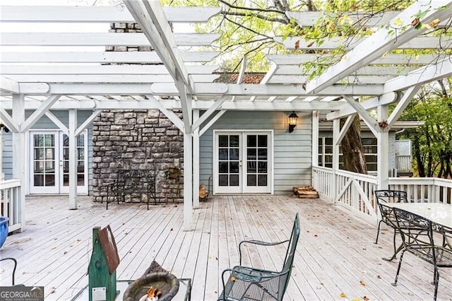 wooden deck featuring a pergola and french doors