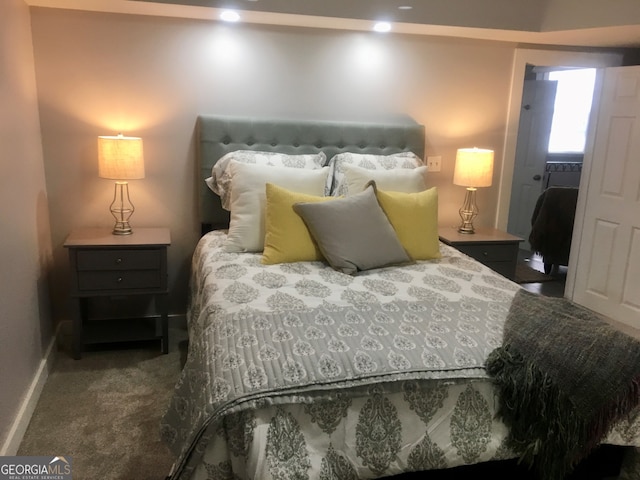 bedroom with dark colored carpet