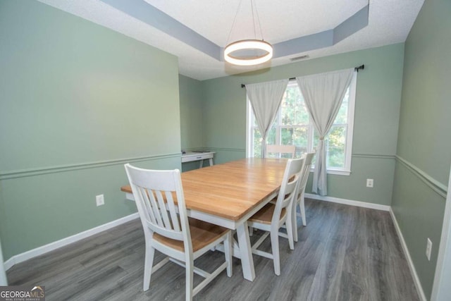 dining room with dark hardwood / wood-style flooring