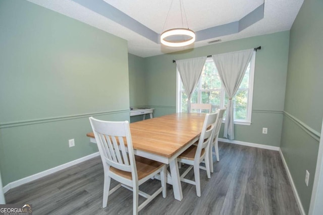 50 Carthedge Trce, Newnan, GA 30263 - dining room with a tray ceiling, visible vents, wood finished floors, and baseboards
