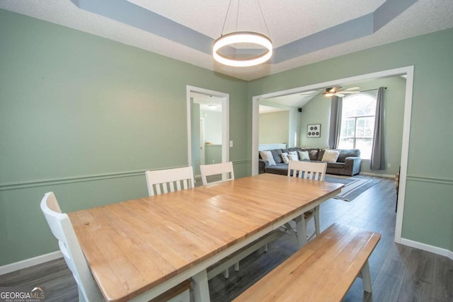50 Carthedge Trce, Newnan, GA 30263 - dining space featuring baseboards, dark wood finished floors, a tray ceiling, and a ceiling fan