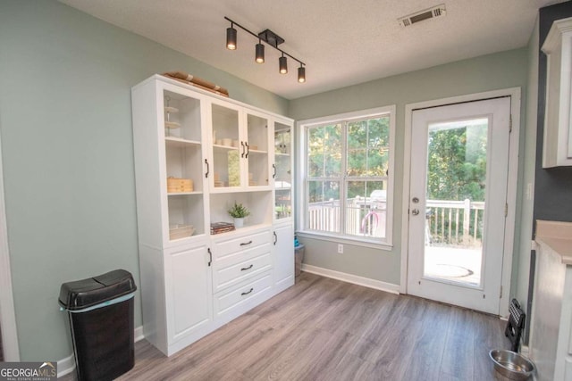 entryway featuring a textured ceiling and light wood-type flooring