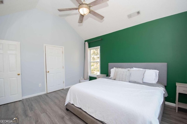 bedroom with vaulted ceiling, hardwood / wood-style flooring, and ceiling fan