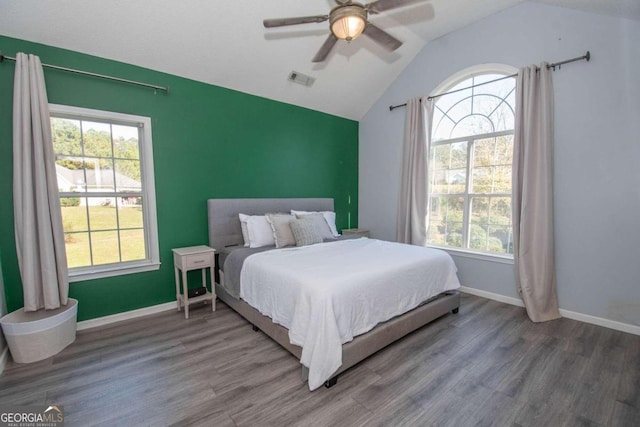 50 Carthedge Trce, Newnan, GA 30263 - bedroom with lofted ceiling, multiple windows, and wood finished floors