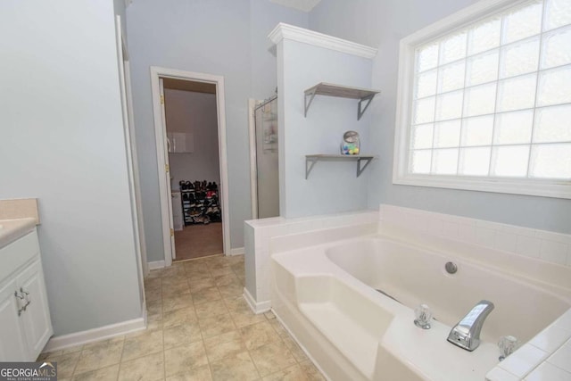 bathroom with vanity, tile patterned flooring, and a washtub