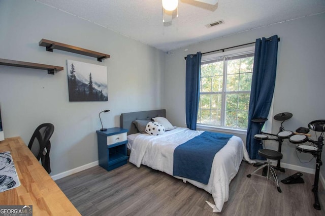50 Carthedge Trce, Newnan, GA 30263 - bedroom featuring baseboards, visible vents, a textured ceiling, and wood finished floors