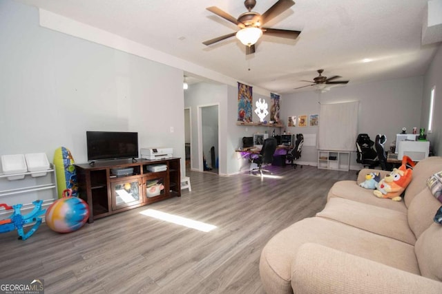 living room with hardwood / wood-style flooring and ceiling fan