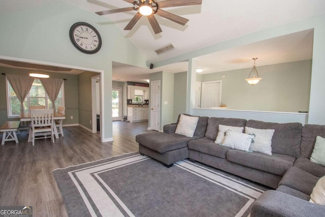 living room with ceiling fan, high vaulted ceiling, and dark hardwood / wood-style floors