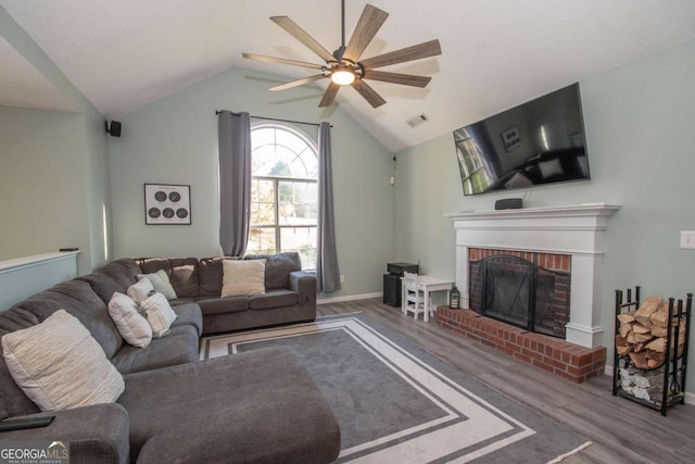 50 Carthedge Trce, Newnan, GA 30263 - living area featuring wood finished floors, a ceiling fan, a brick fireplace, visible vents, and lofted ceiling