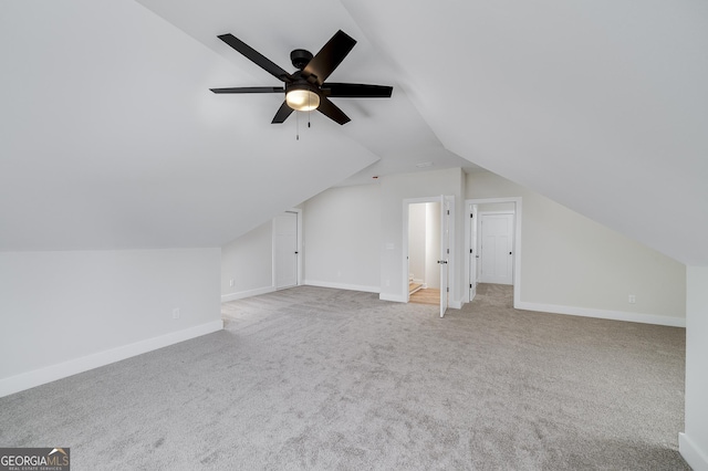 additional living space featuring ceiling fan, light colored carpet, and lofted ceiling