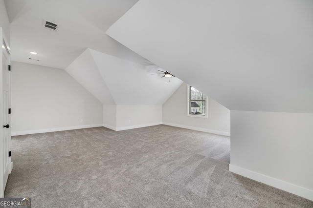 bonus room with light carpet and lofted ceiling