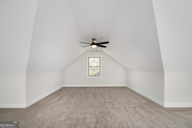 additional living space featuring light carpet, vaulted ceiling, and ceiling fan