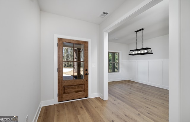 foyer entrance with light hardwood / wood-style flooring