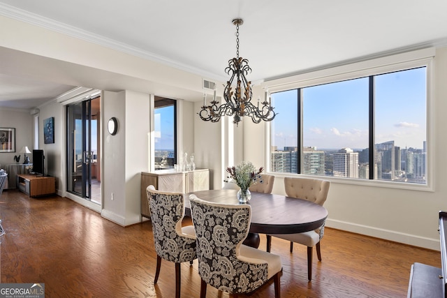 dining space with a city view, crown molding, and visible vents