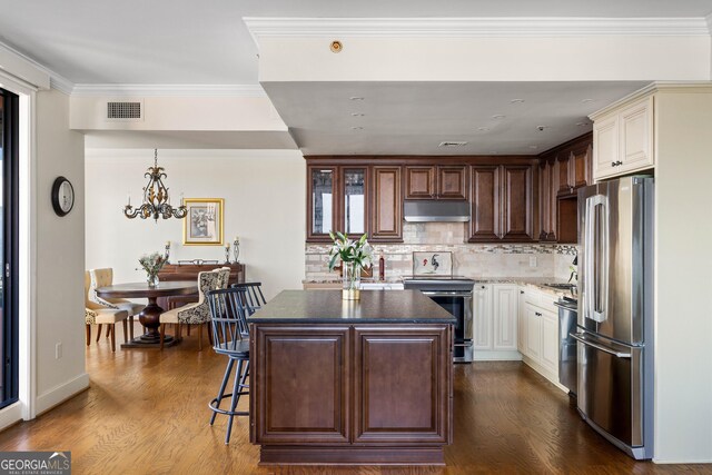 living room with ornamental molding and dark hardwood / wood-style floors