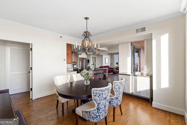 dining area featuring dark wood-style floors, visible vents, and baseboards