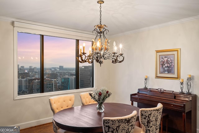 dining room with a city view, crown molding, baseboards, and wood finished floors