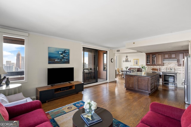 living area with baseboards, crown molding, visible vents, and dark wood-type flooring