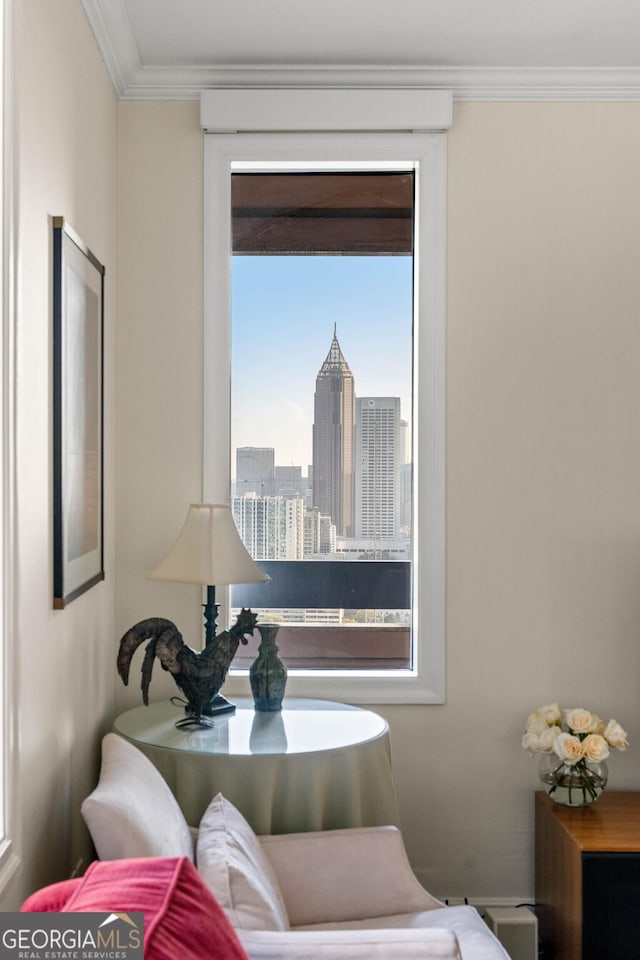 living area featuring ornamental molding and a view of city