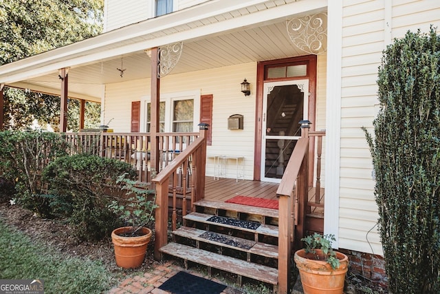 view of exterior entry with a porch