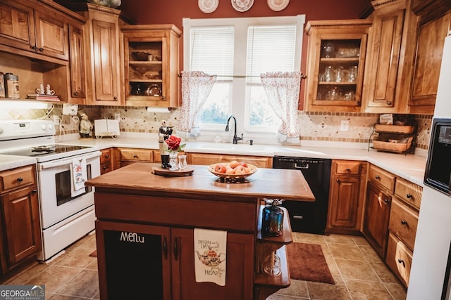 kitchen featuring dishwasher, a kitchen island, sink, and white electric stove