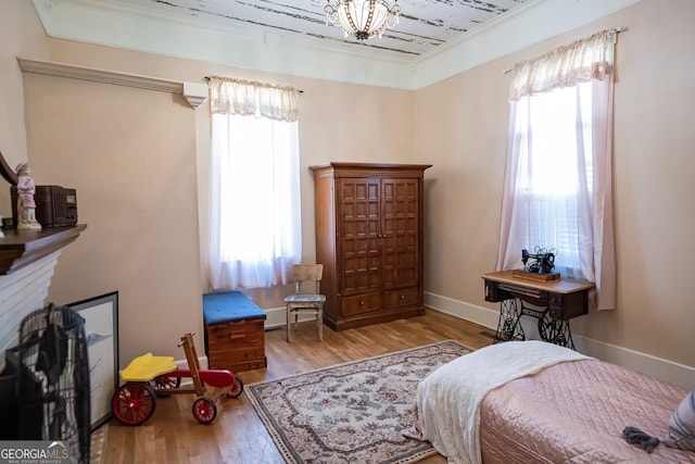 bedroom featuring light hardwood / wood-style floors and ornamental molding