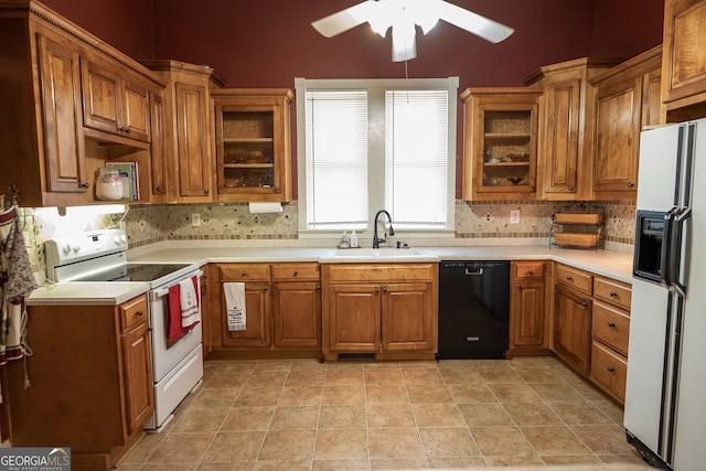 kitchen with light tile patterned floors, white appliances, tasteful backsplash, and sink