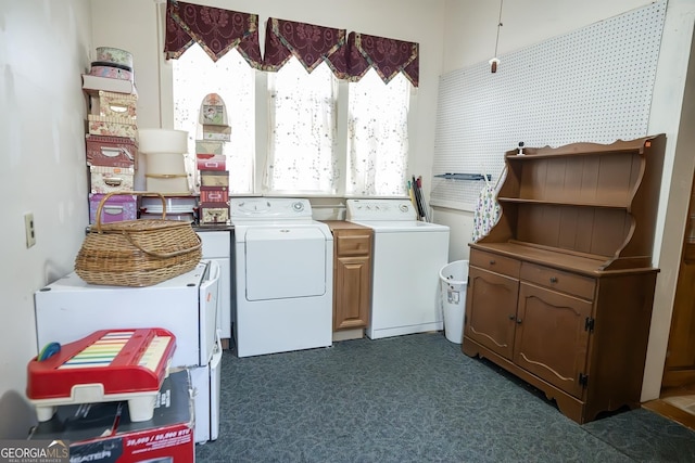 laundry area featuring washing machine and clothes dryer and cabinets