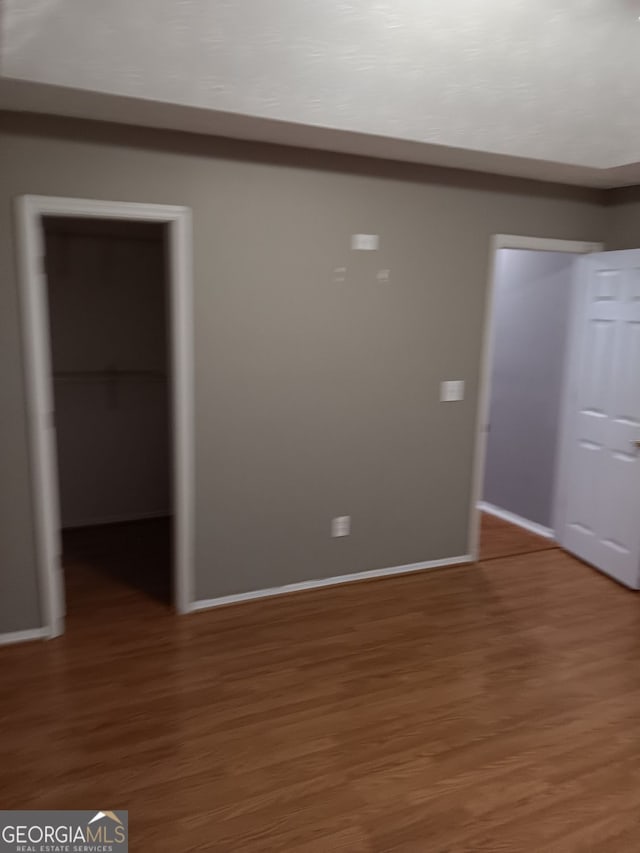 spare room with hardwood / wood-style flooring