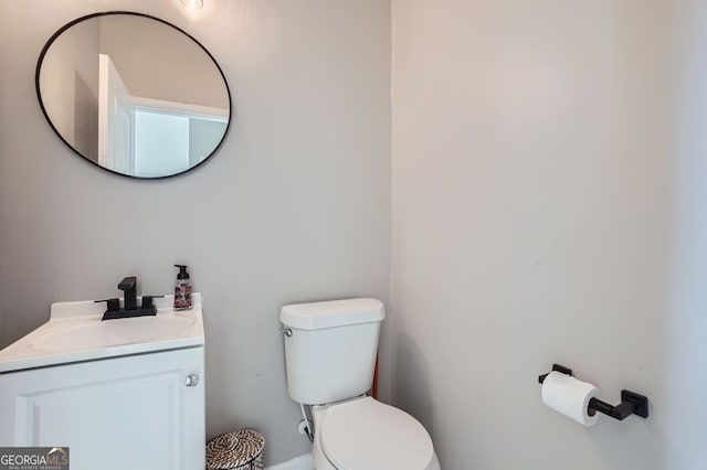 bathroom featuring vanity and toilet