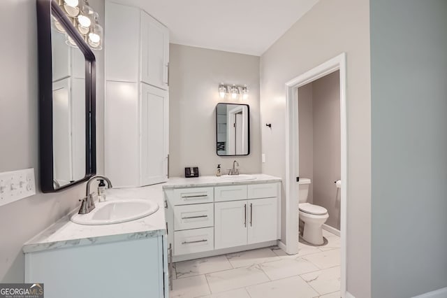 bathroom featuring toilet and vanity