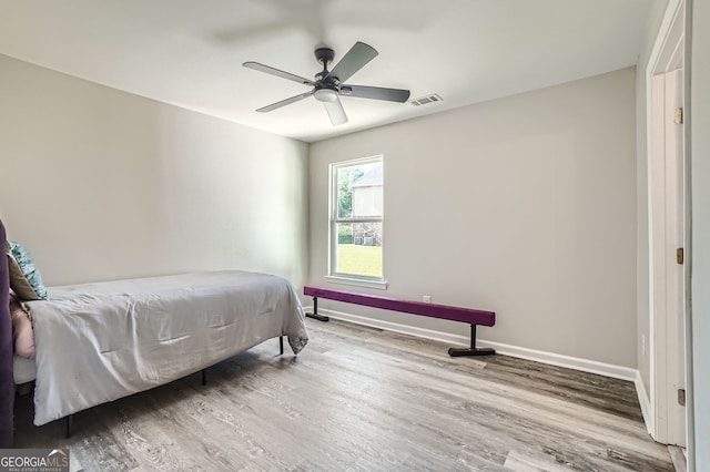 bedroom with hardwood / wood-style flooring and ceiling fan