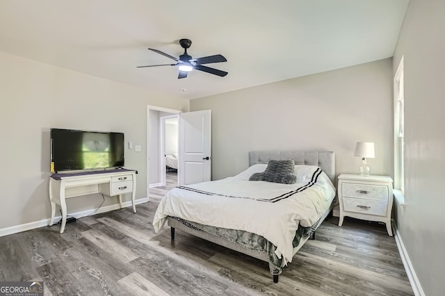 bedroom with wood-type flooring and ceiling fan